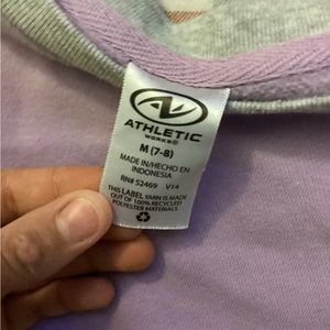 It is a cute purple sweater for ages, seven and eight for the cold is in season